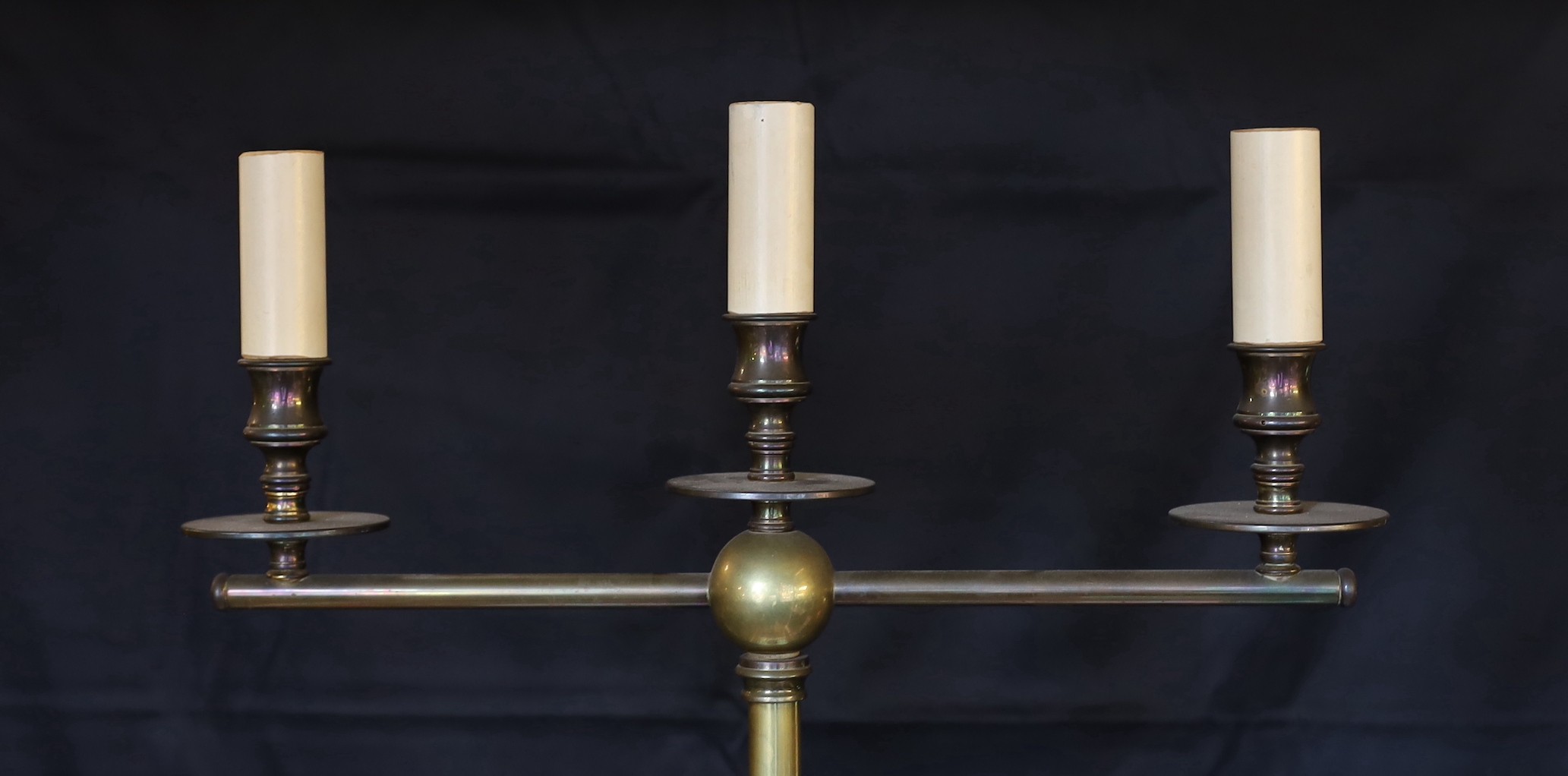 A lacquered brass three light lamp standard, with spiral fluted column and simulated candlestick sconces, height 172cm